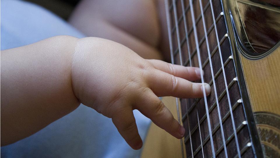 Baby plays guitar
