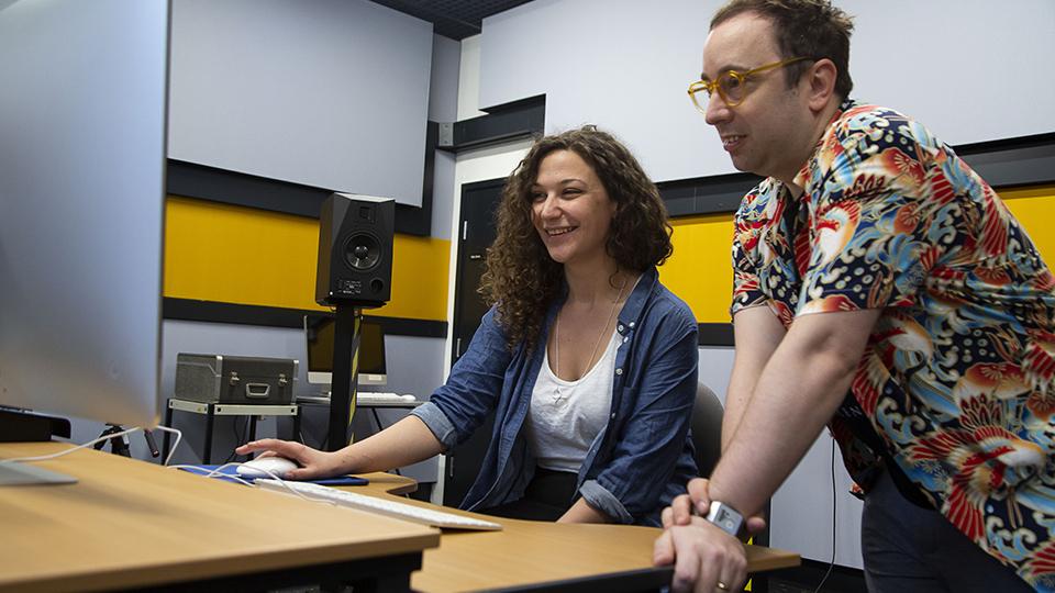 Lamis (Ell) Harper and Paul Sandell from EMIPM look at a computer in the music studios