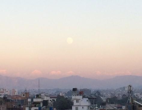 Photo of a full moon over the city of Kathmandu 