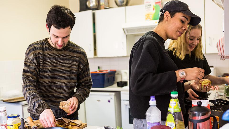 Students cooking dinner together in halls