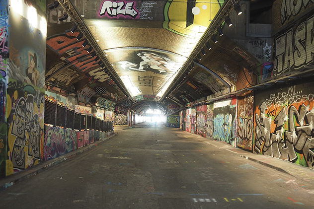 Tunnel surrounded by graffiti artwork