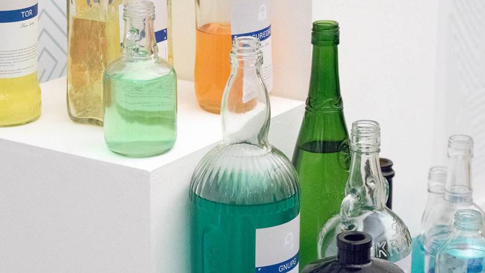 Green bottles standing on a white box