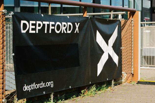 A wall banner advertising the Deptford X arts festival
