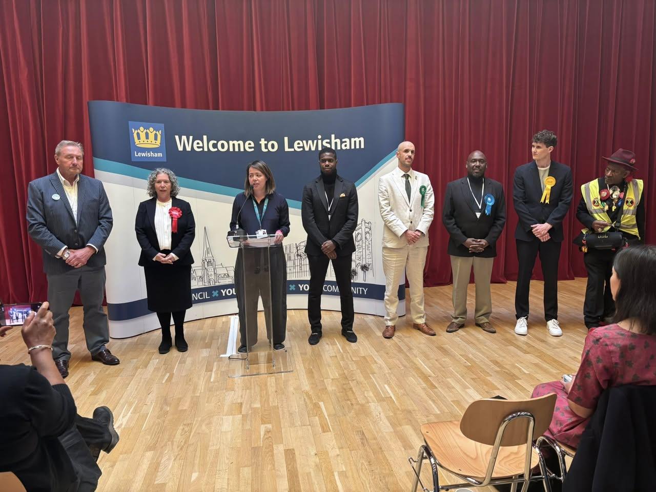 Liam pictured in a white suit, at the Mayor election results announcement. 