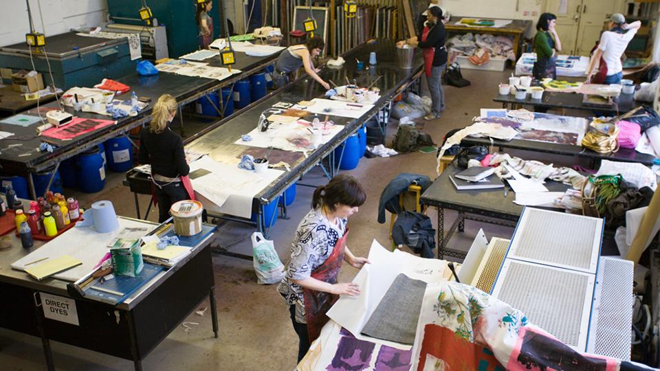 Art students working in one of the art practice areas
