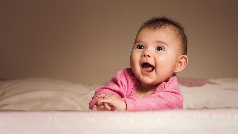 Baby in pink laughing
