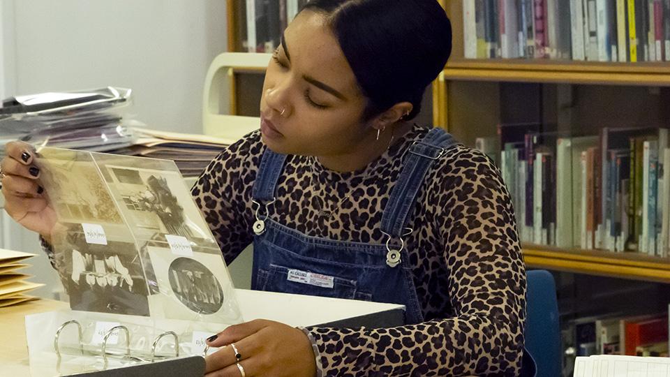 A students looking through Library Special Collection materials 