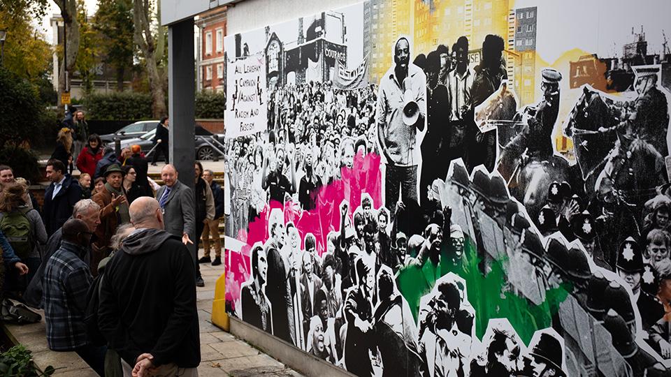 A photo of the mural and gathered crowd