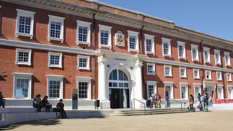 A picture of the front of the Richard Hoggart Building, a large red-brick Victorian structure