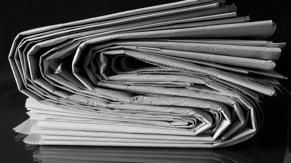 A pile of folded newspapers