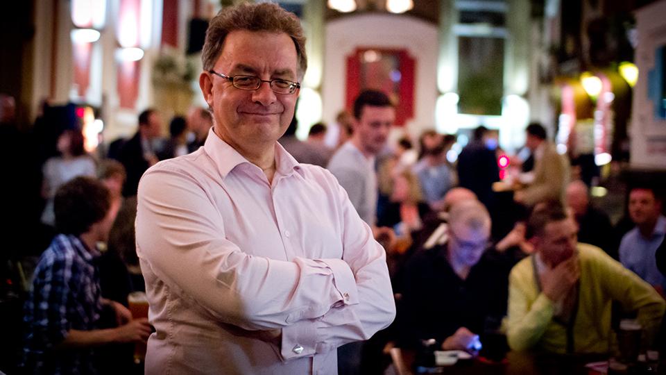 An image of the interviewee Chris French standing in front of an audience in a pub