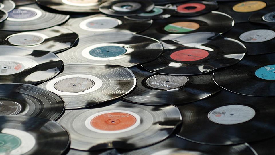 Photo shows a pile of vinyl records