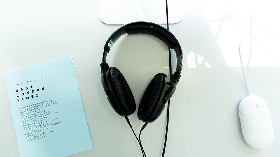 An image of a set of headphones, computer mouse and East London Lines publication 