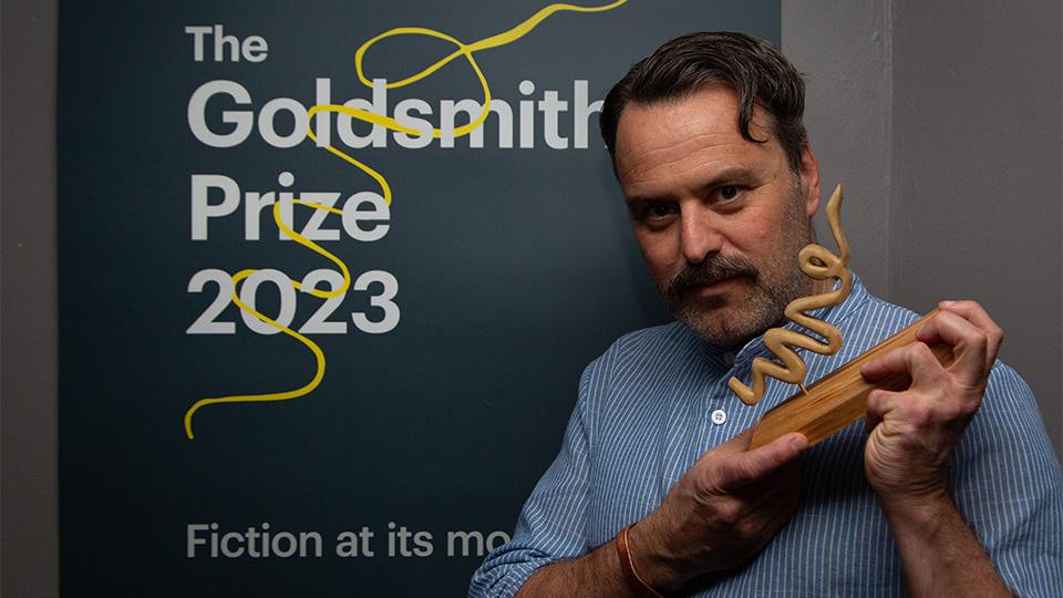 Benjamin Myers holding the Goldsmiths Prize 2023
