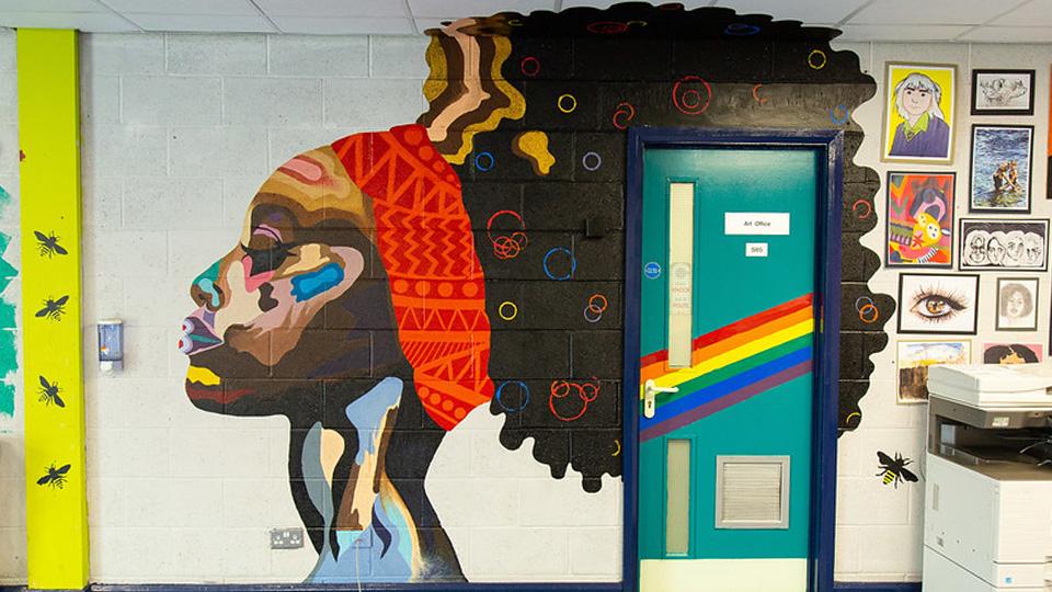 A classroom door with a mural painted around it.