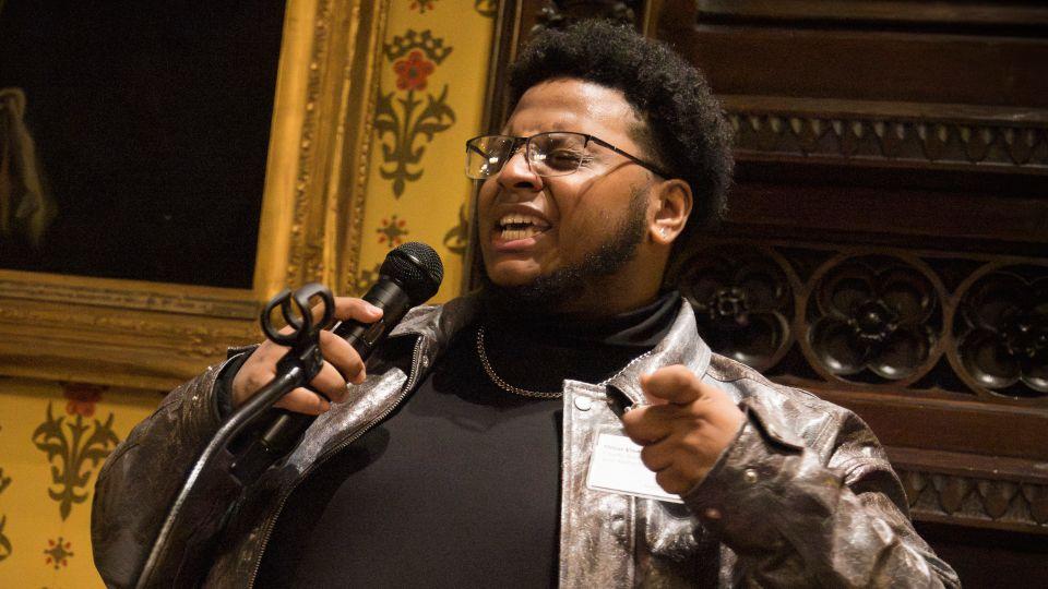 Young male performs into mic