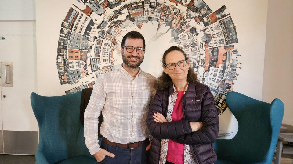Dr Pentaris and Lisa Williams standing in front of some blue chairs