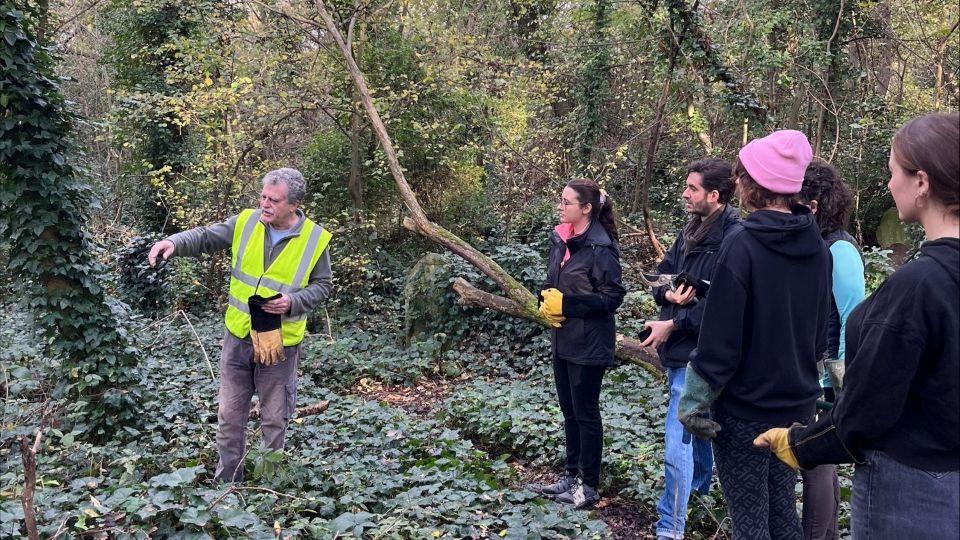 A Friends of Nunhead Cemetery volunteer demonstrates to staff one of the areas which needed to be clear