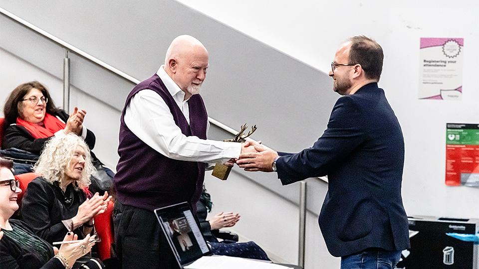 Programme founder Gerald Lidstone and current co-director Dr Aleksander Brkić warmly shake hands. 