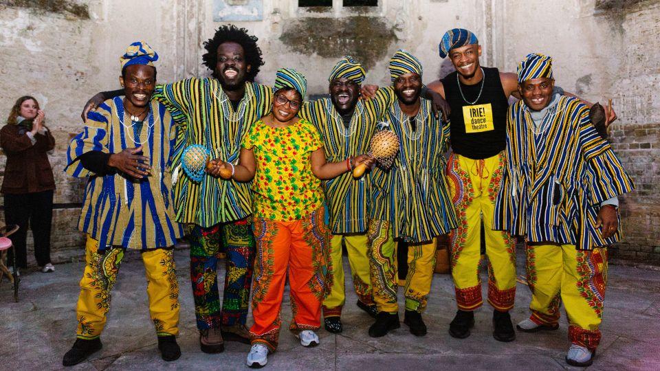 Performers from IRIE! dance theatre smile for a photograph in the chapel ruins 