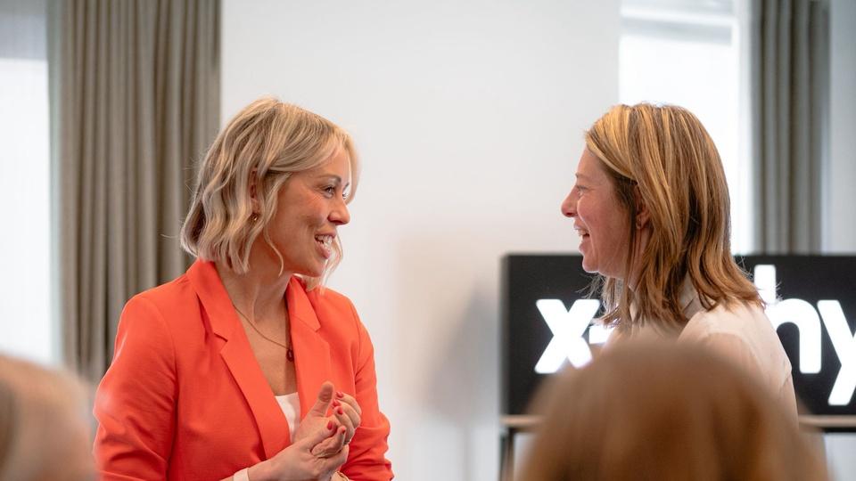 Two female participants in conversation during the Scale Creative Leaders event.