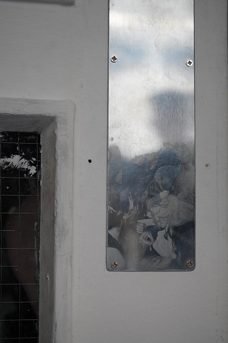 Etched finger plate artwork on a door