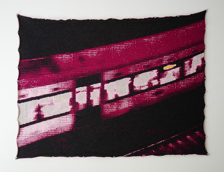 Knitted artwork showcasing pixelated textile