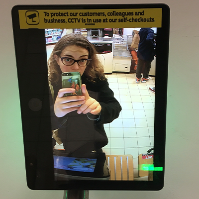 Dr Jennifer Fleetwood taking a selfie on CCTV at a supermarket self-checkout