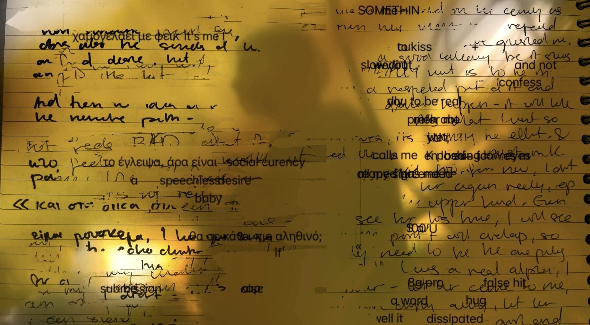 A person's shadow falls across a collage of handwritten and typed text on paper.