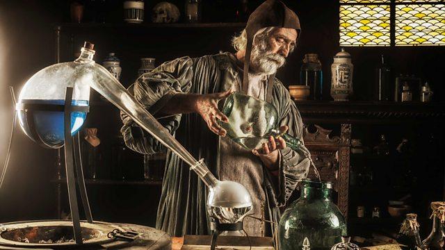 Photograph of a man making a potion