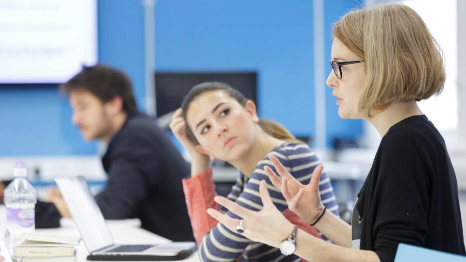 Students in conversation in a classroom.