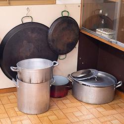 Large pans in the corner of a kitchen