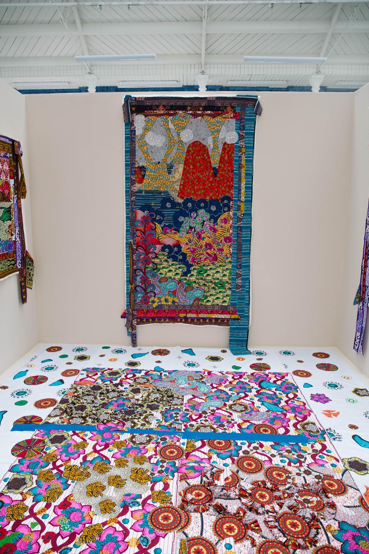 A room featuring a decorative rug on the floor and a large painting displayed on the wall