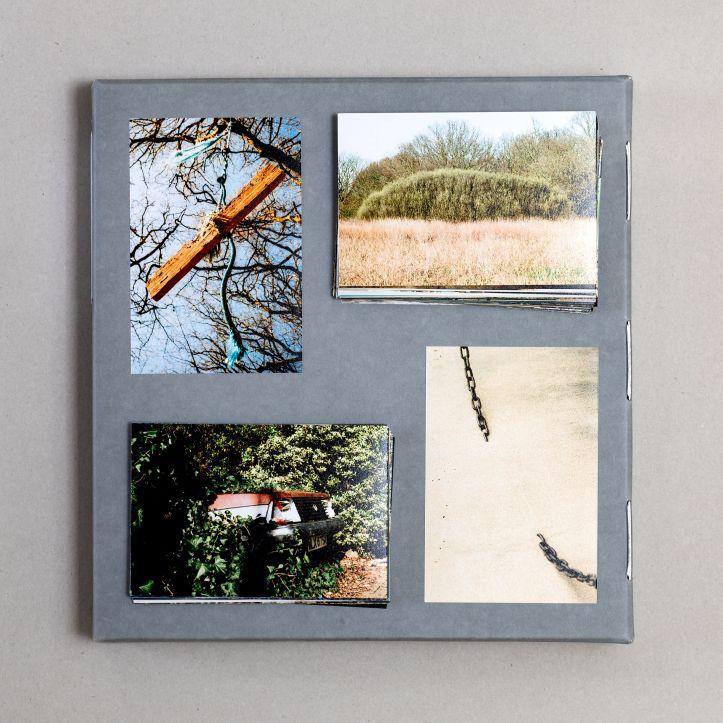 Four photographs on a grey page. One shows branches against the sky with a wooden beam, one shows some grass and shrubs, one shows a car overgrown in a hedge, and one shows a chain disappearing into sand. 