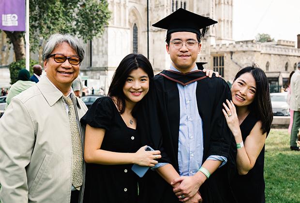 A tall grad with his family