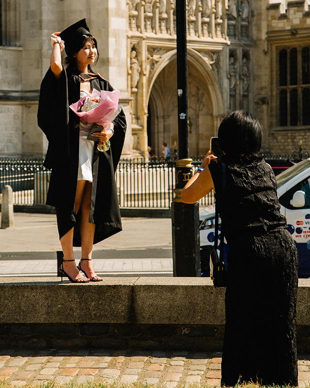 Grad with flowers gets her photo taken