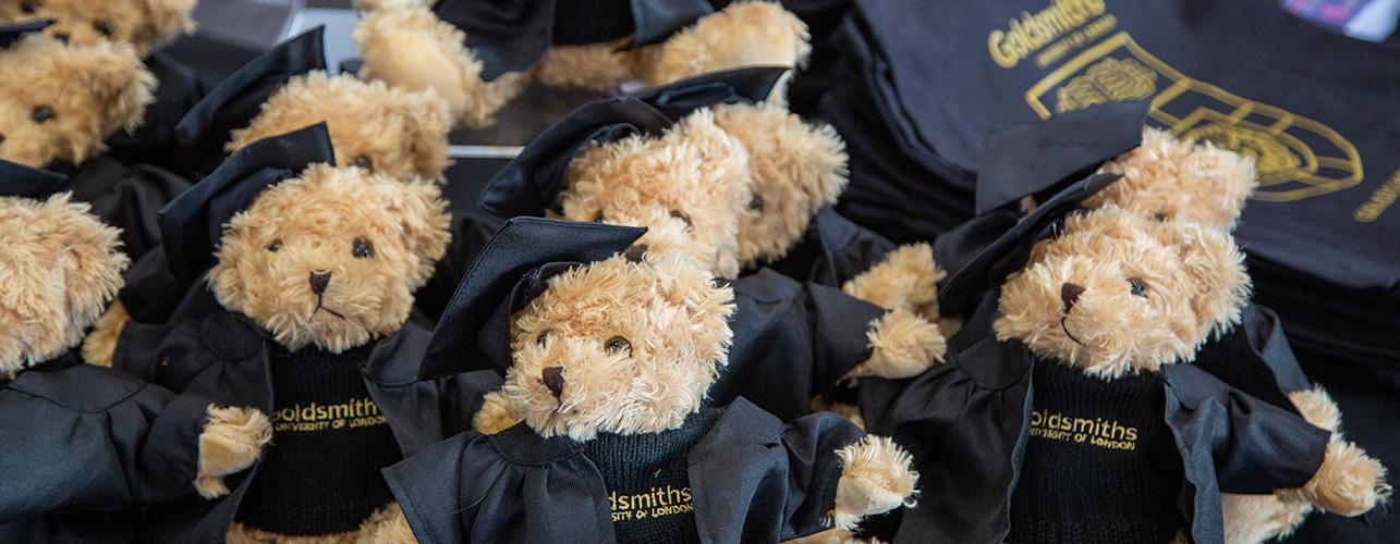 Graduation teddy bears lined up on a table.