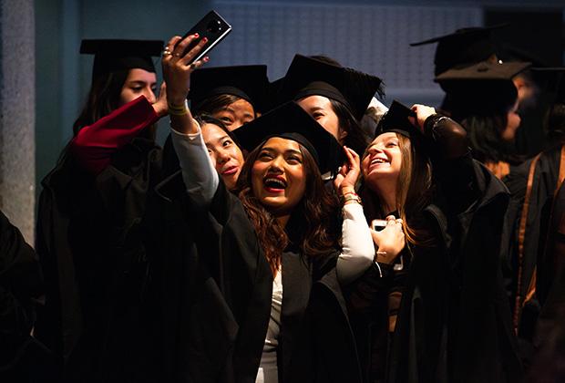 Big group of graduates take a selfie before the ceremony