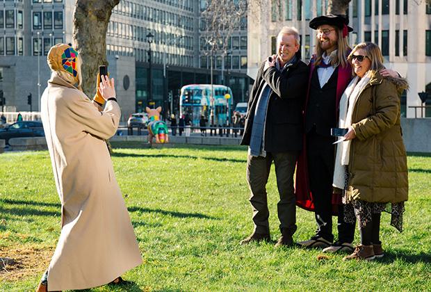 A graduate and his family have their photo taken