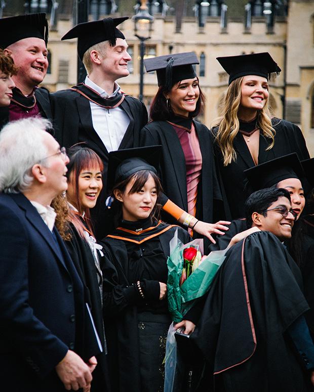 Big group of graduates posing outside