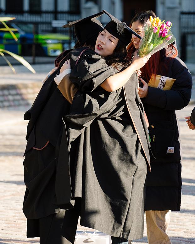 Graduates hug outside