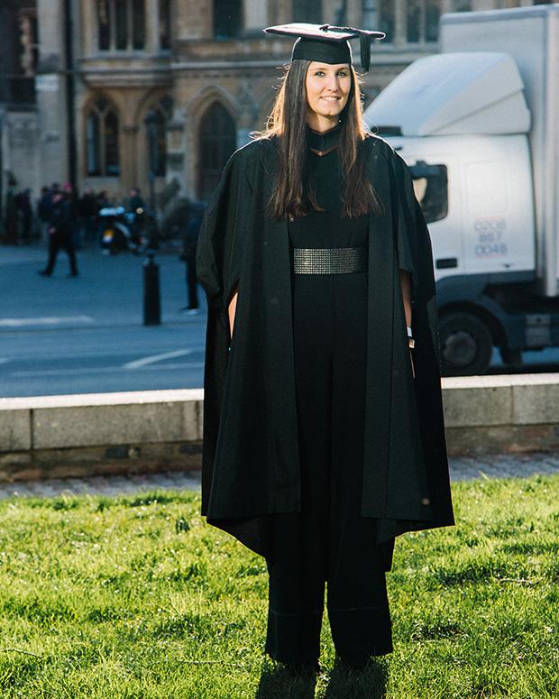  Graduate poses outside for a photo