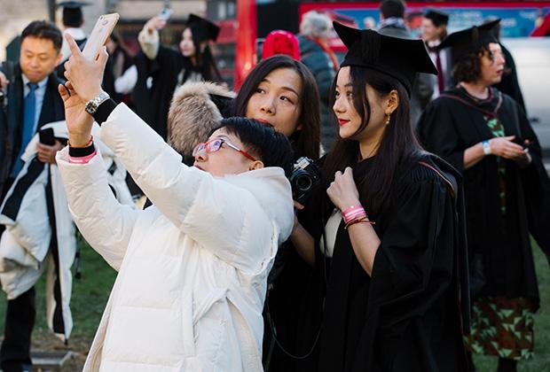 A family take a group selfie