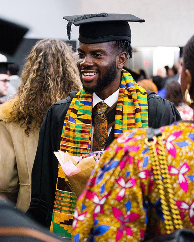 Graduate at the reception in a brightly coloured scarf