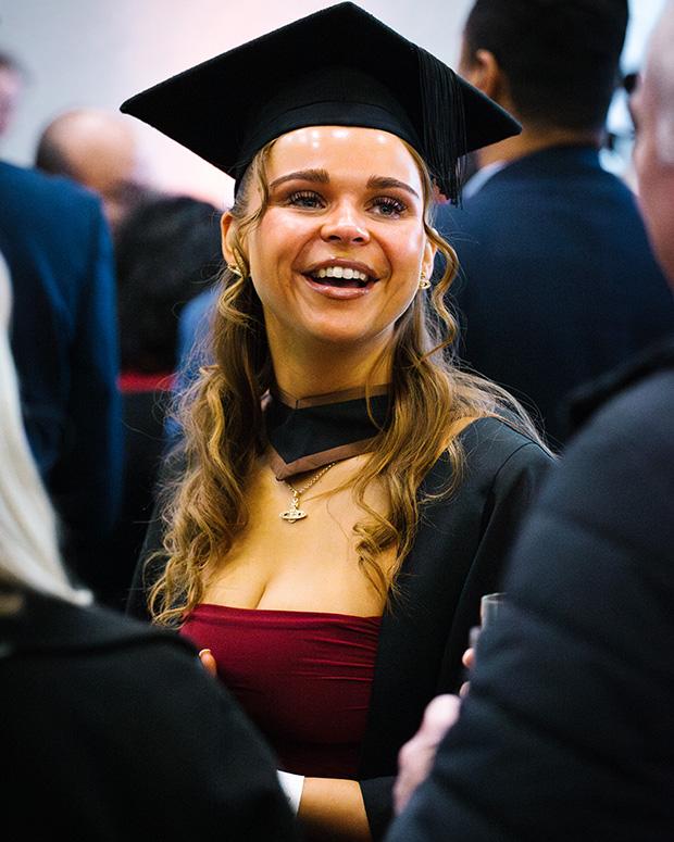 Portrait of a graduate smiling at the reception