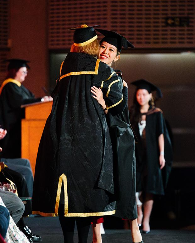 Graduate hugs the Chair of Council