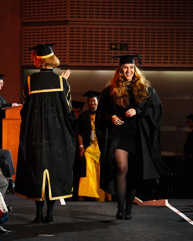 Graduate smiles as she crosses the stage