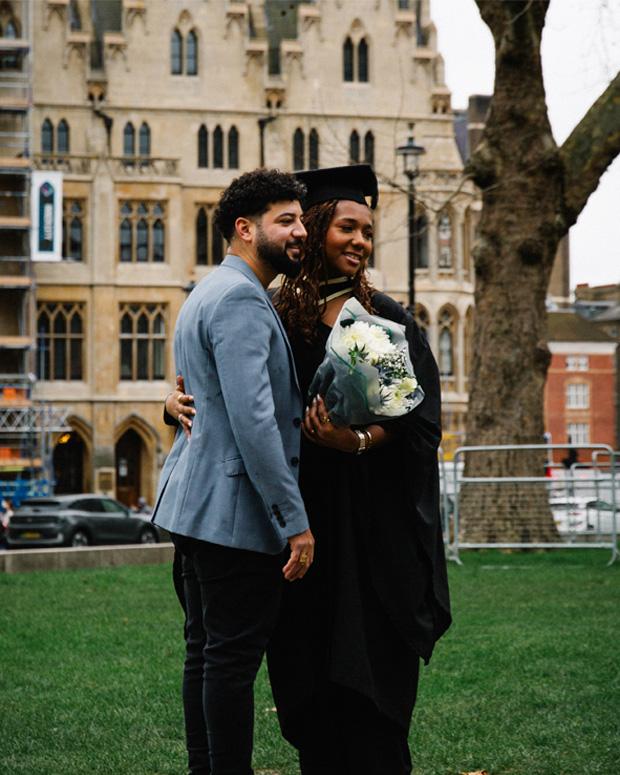 A graduate hugs a supporter in westminster