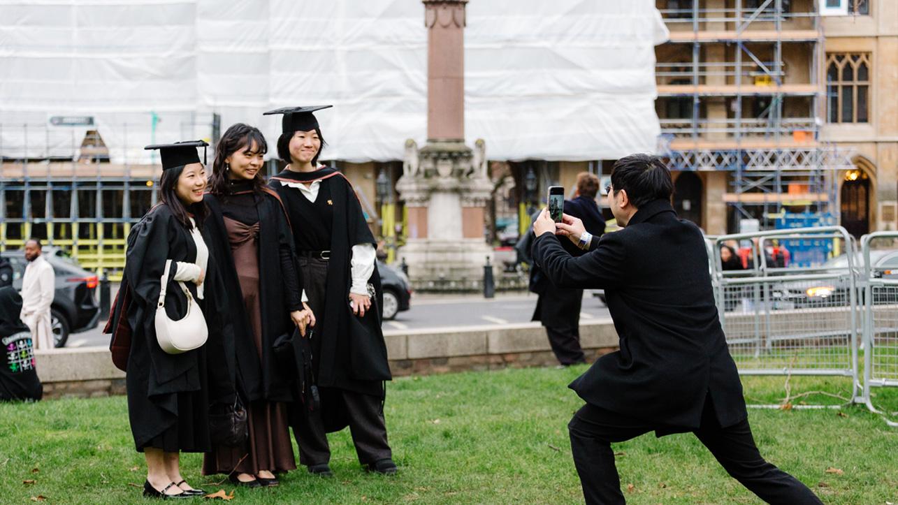 Students pose for a photo outside their graduation ceremony.
