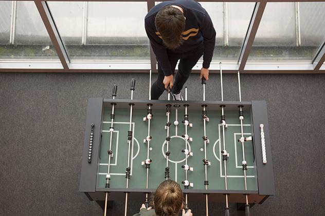 Students playing table football in halls